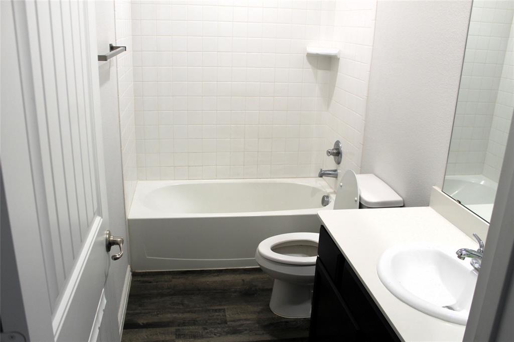 515 Cottage Row Mabank, TX 75147 - Photo 13 of 16 a bathroom with a sink toilet and shower