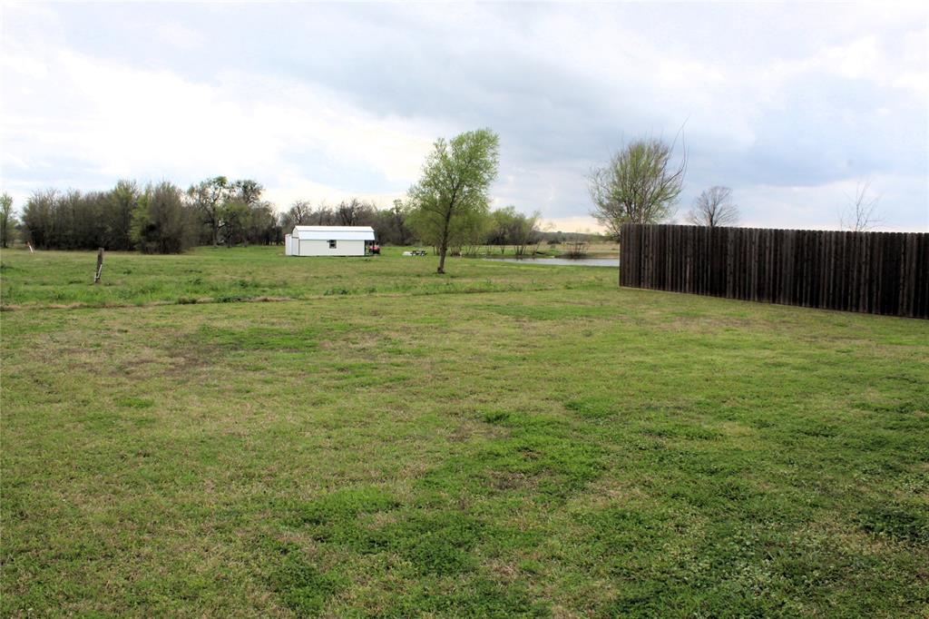 515 Cottage Row Mabank, TX 75147 - Photo 15 of 16 a view of a field with wooden fence
