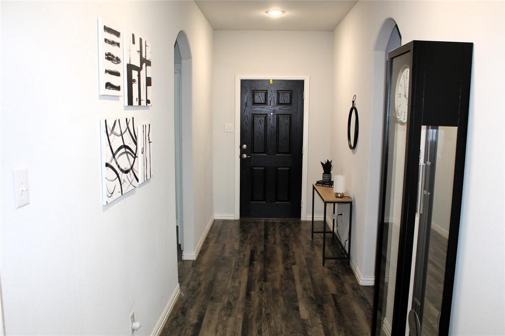 515 Cottage Row Mabank, TX 75147 - Photo 2 of 16 a view of a hallway with wooden floor