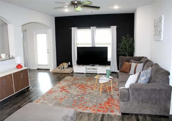 a living room with furniture and a flat screen tv