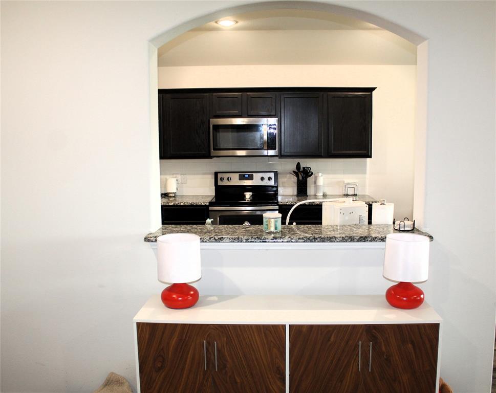 515 Cottage Row Mabank, TX 75147 - Photo 4 of 16 a kitchen with a sink a stove and cabinets
