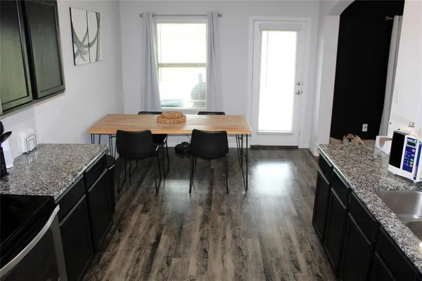a kitchen with granite countertop lots of counter top space and a window