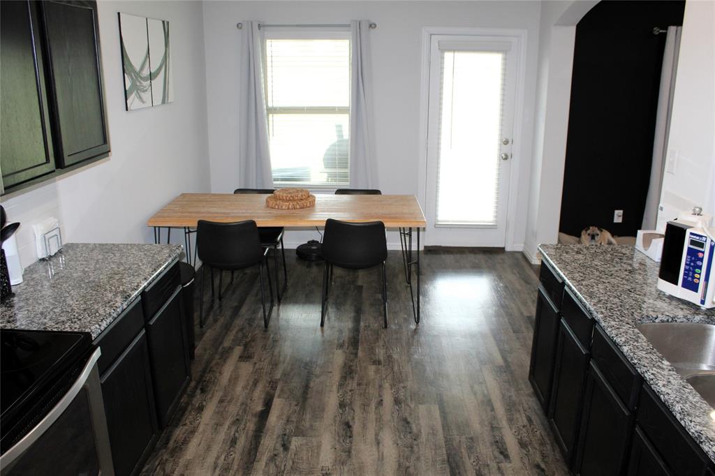 515 Cottage Row Mabank, TX 75147 - Photo 8 of 16 a kitchen with granite countertop lots of counter top space and a window
