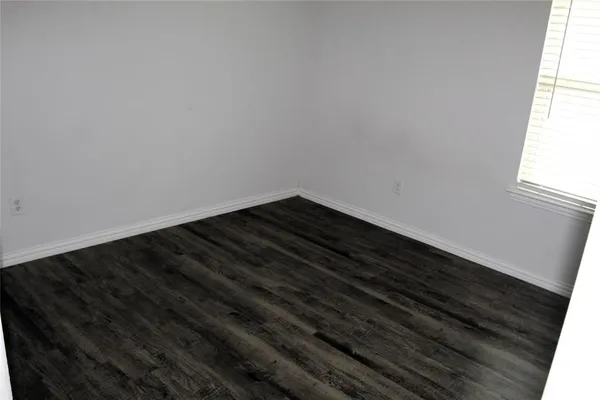 a view of room with wooden floor and a window