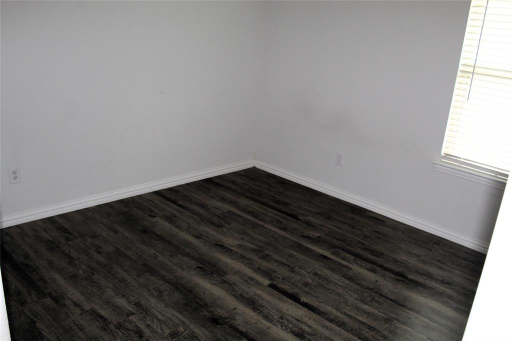 515 Cottage Row Mabank, TX 75147 - Photo 10 of 16 a view of room with wooden floor and a window