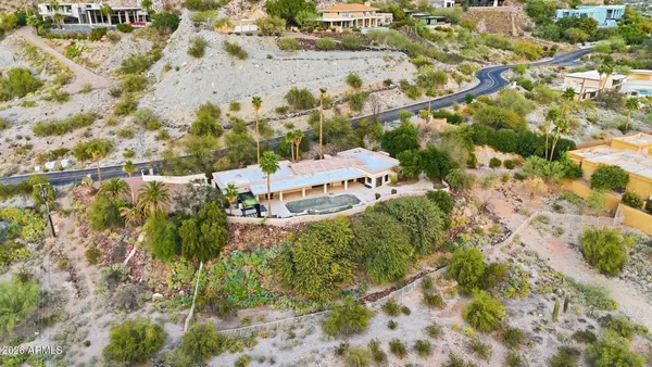 an aerial view of a house with a yard