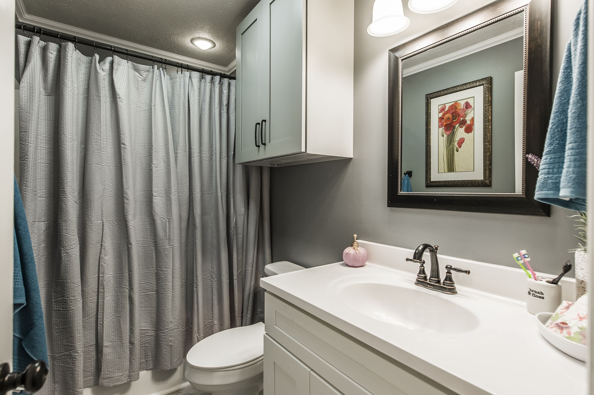 3014 Academy Road Portland, TN 37148 - Photo 21 of 42 a bathroom with a sink a toilet and shower curtain