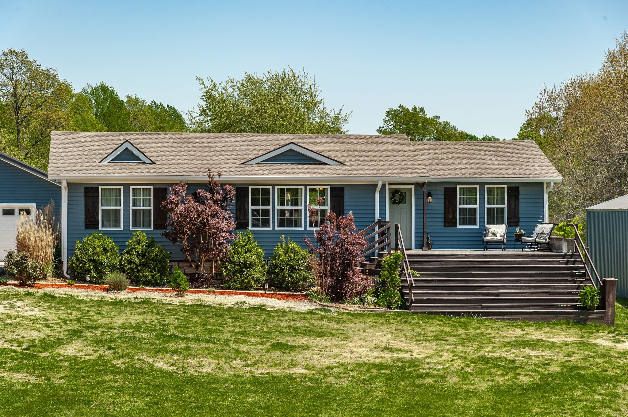 3014 Academy Road Portland, TN 37148 - Photo 4 of 42 a view of a house with a yard potted plants and a bench