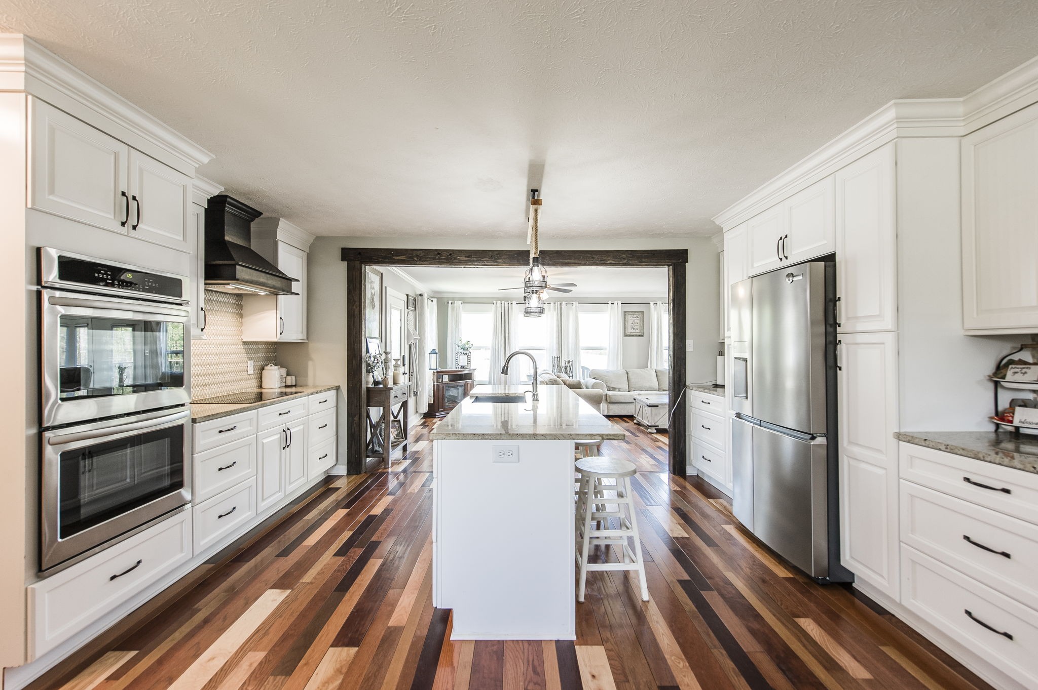 3014 Academy Road Portland, TN 37148 - Photo 9 of 42 a kitchen with counter top space stainless steel appliances and wooden floor