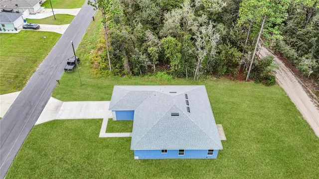 an aerial view of a house with swimming pool yard and outdoor seating