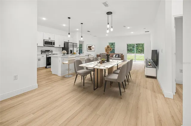 a view of a dining room with furniture and wooden floor
