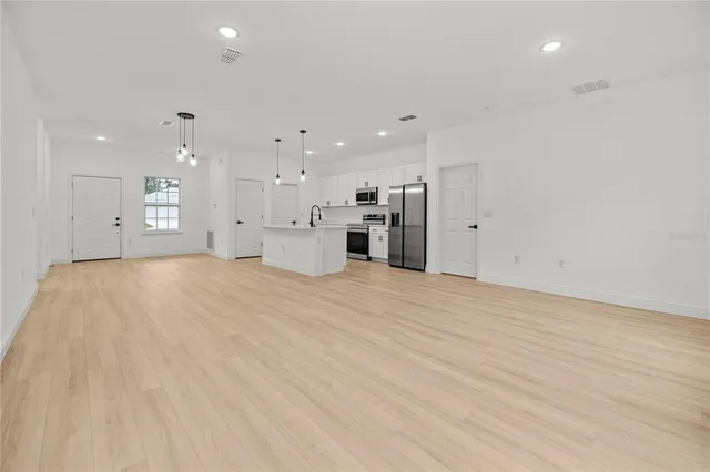 a view of a kitchen with a sink and a refrigerator