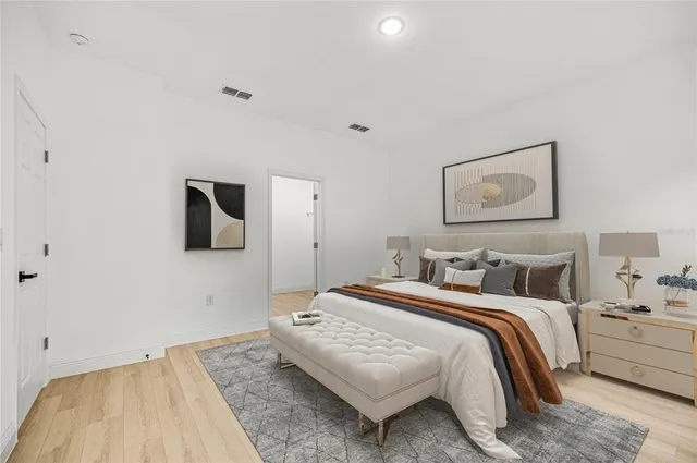 a bedroom with a bed and a painting on the wall