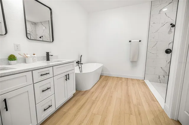 a spacious bathroom with a bathtub and a sink