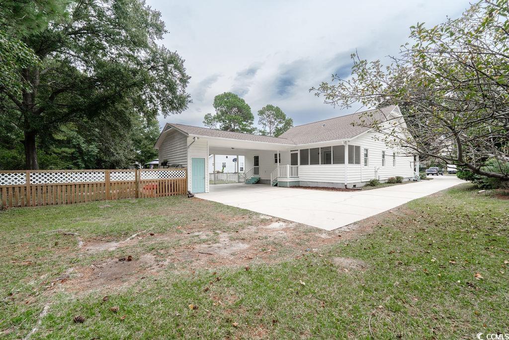 71 Great Lakes Road Pawleys Island, SC 29585 - Photo 31 of 32 View of front of home with a sunroom and a carport