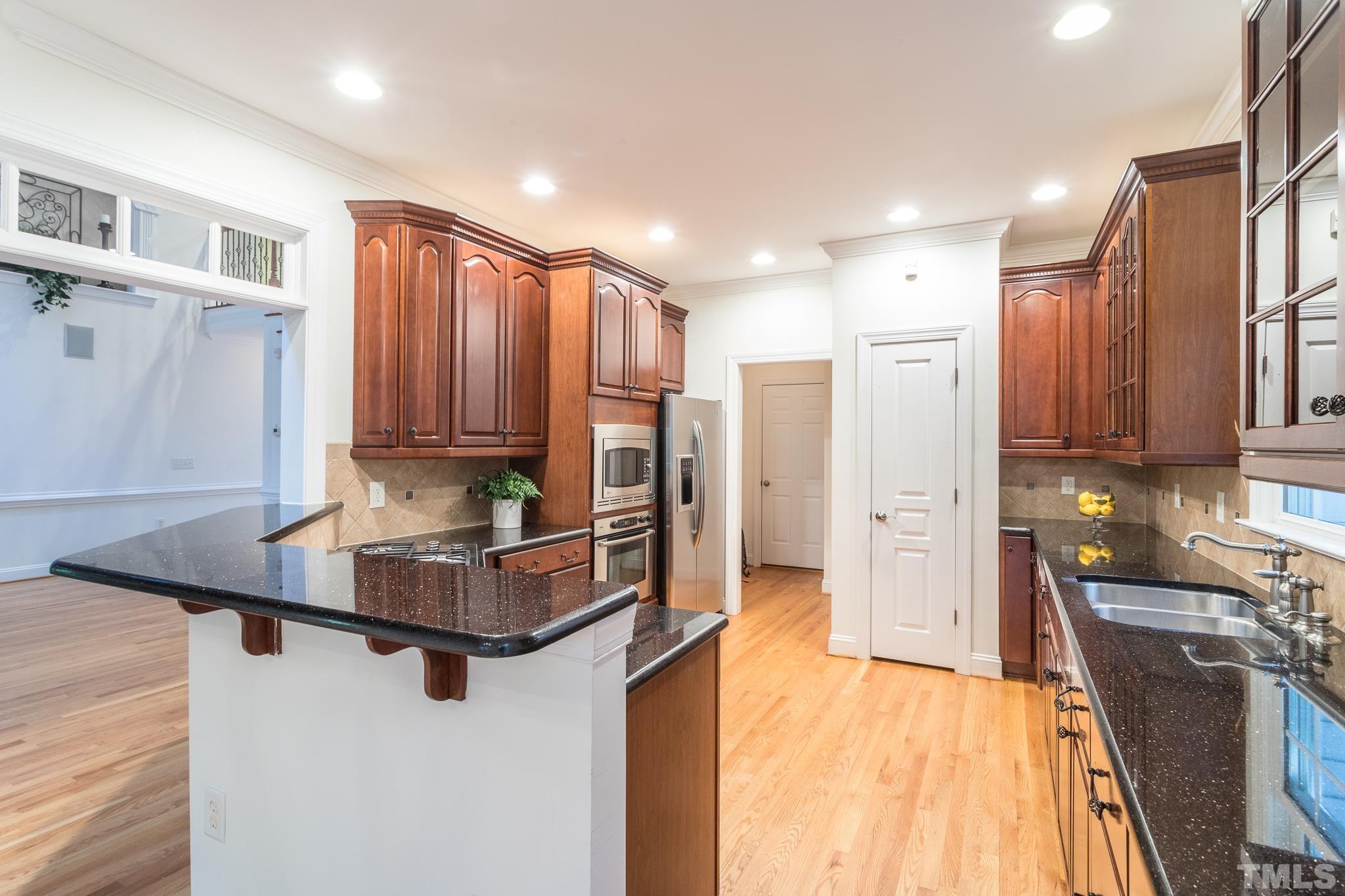 11625 John Allen Road Raleigh, NC 27614 - Photo 13 of 30 a kitchen with stainless steel appliances granite countertop a refrigerator a stove and a sink with cabinets