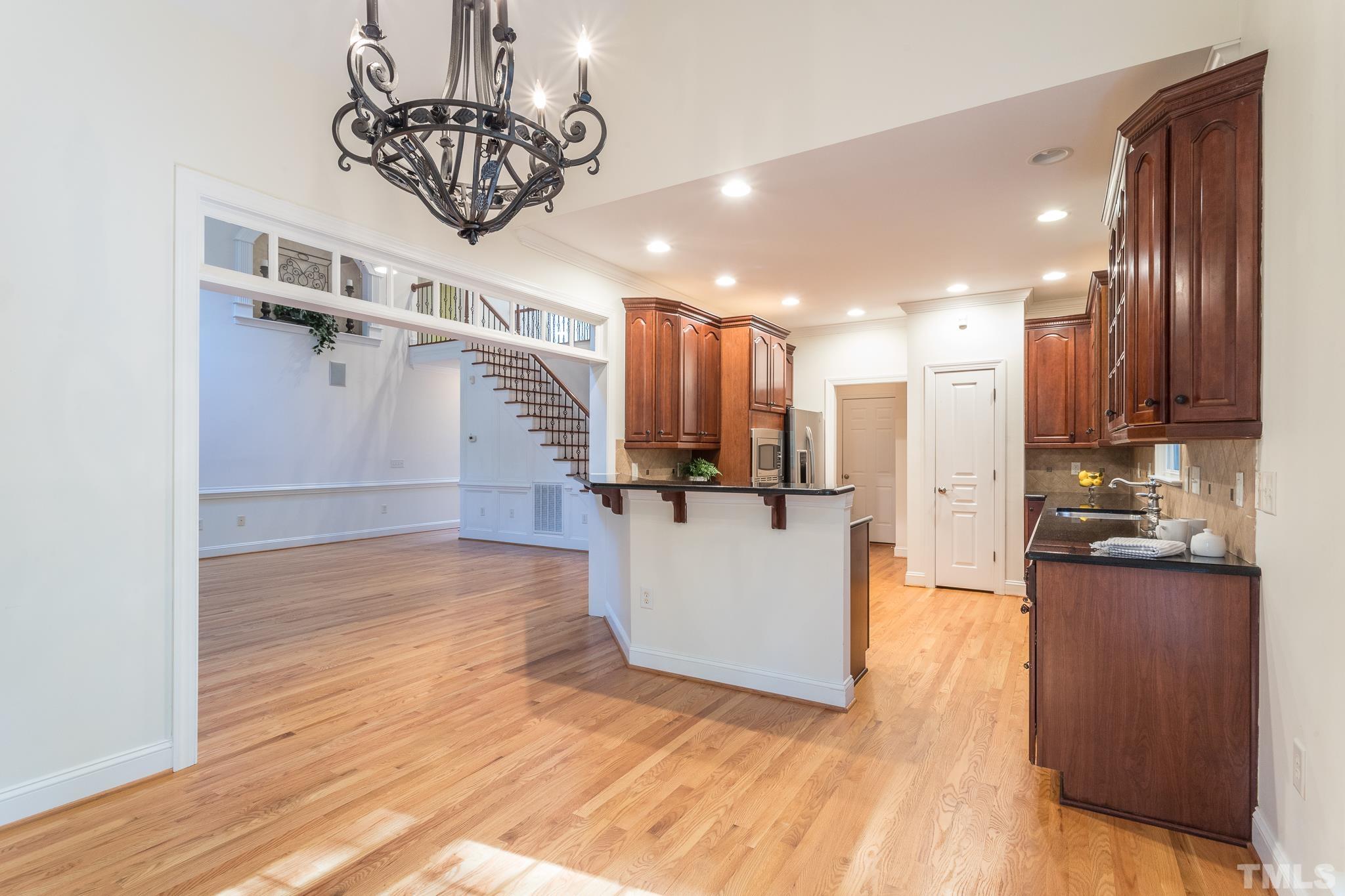 11625 John Allen Road Raleigh, NC 27614 - Photo 15 of 30 a view of a kitchen with a kitchen island wooden floor stainless steel appliances and a window