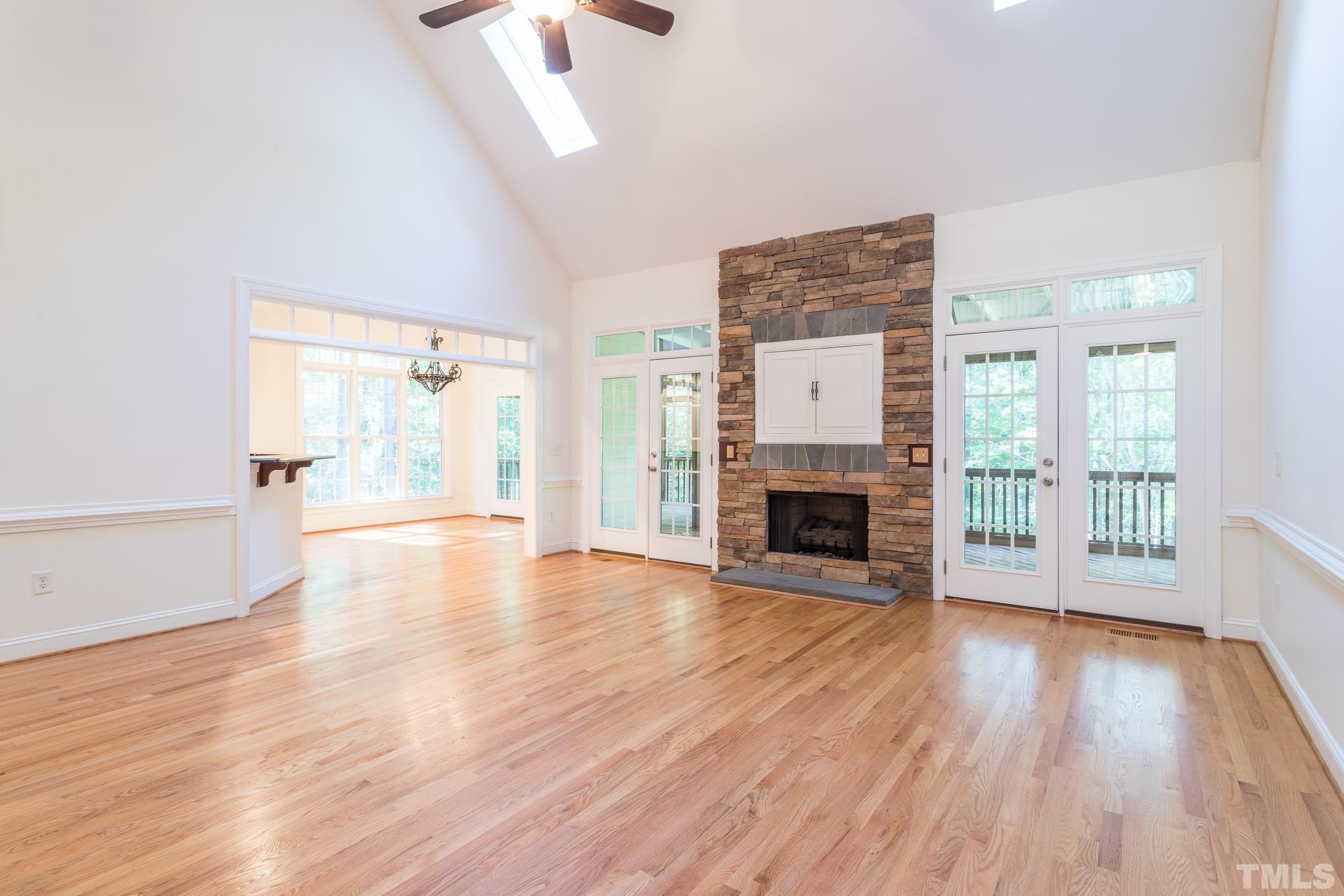 11625 John Allen Road Raleigh, NC 27614 - Photo 19 of 30 wooden floor fireplace and windows in an empty room