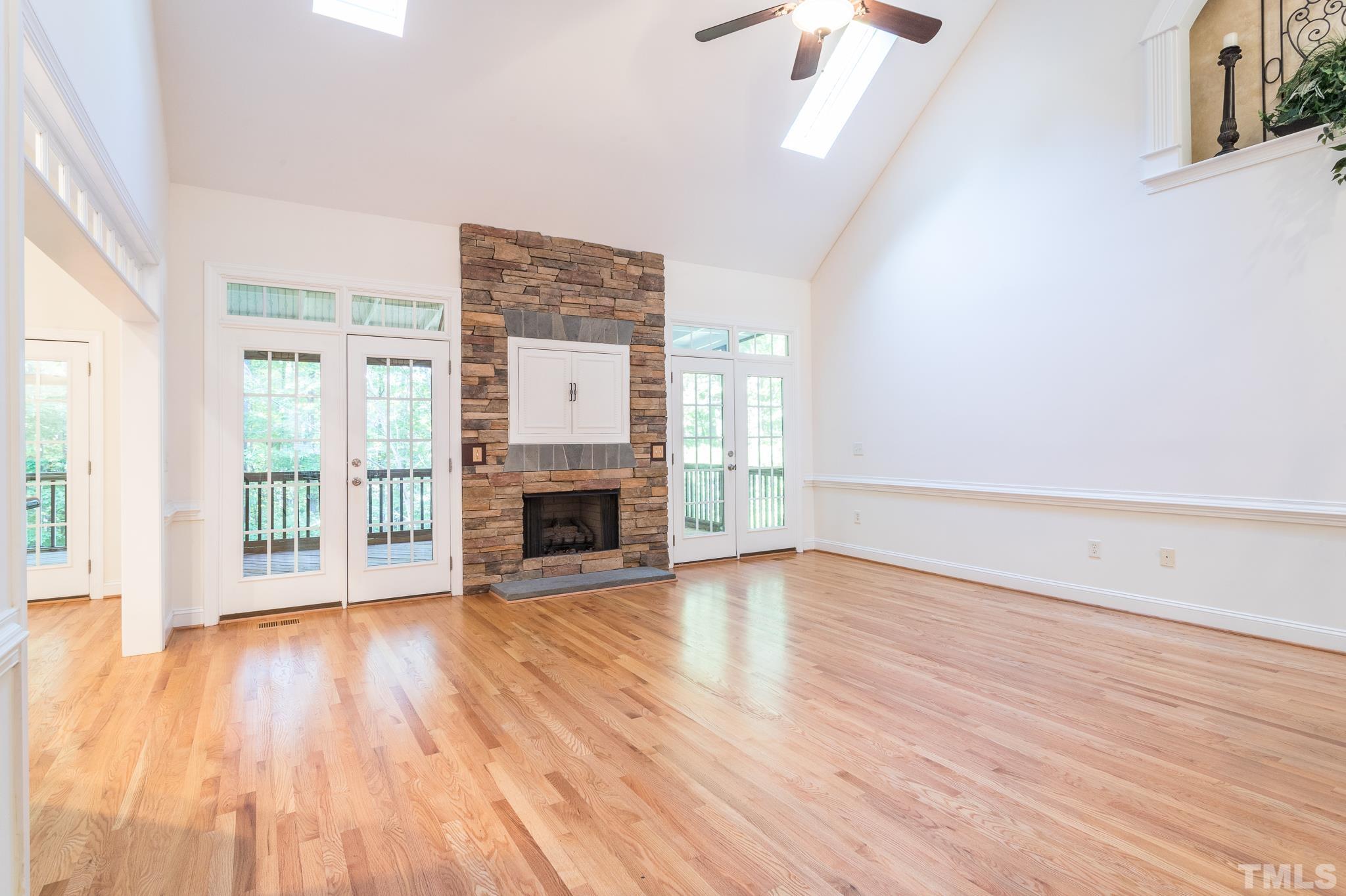 11625 John Allen Road Raleigh, NC 27614 - Photo 21 of 30 wooden floor fireplace and windows in an empty room