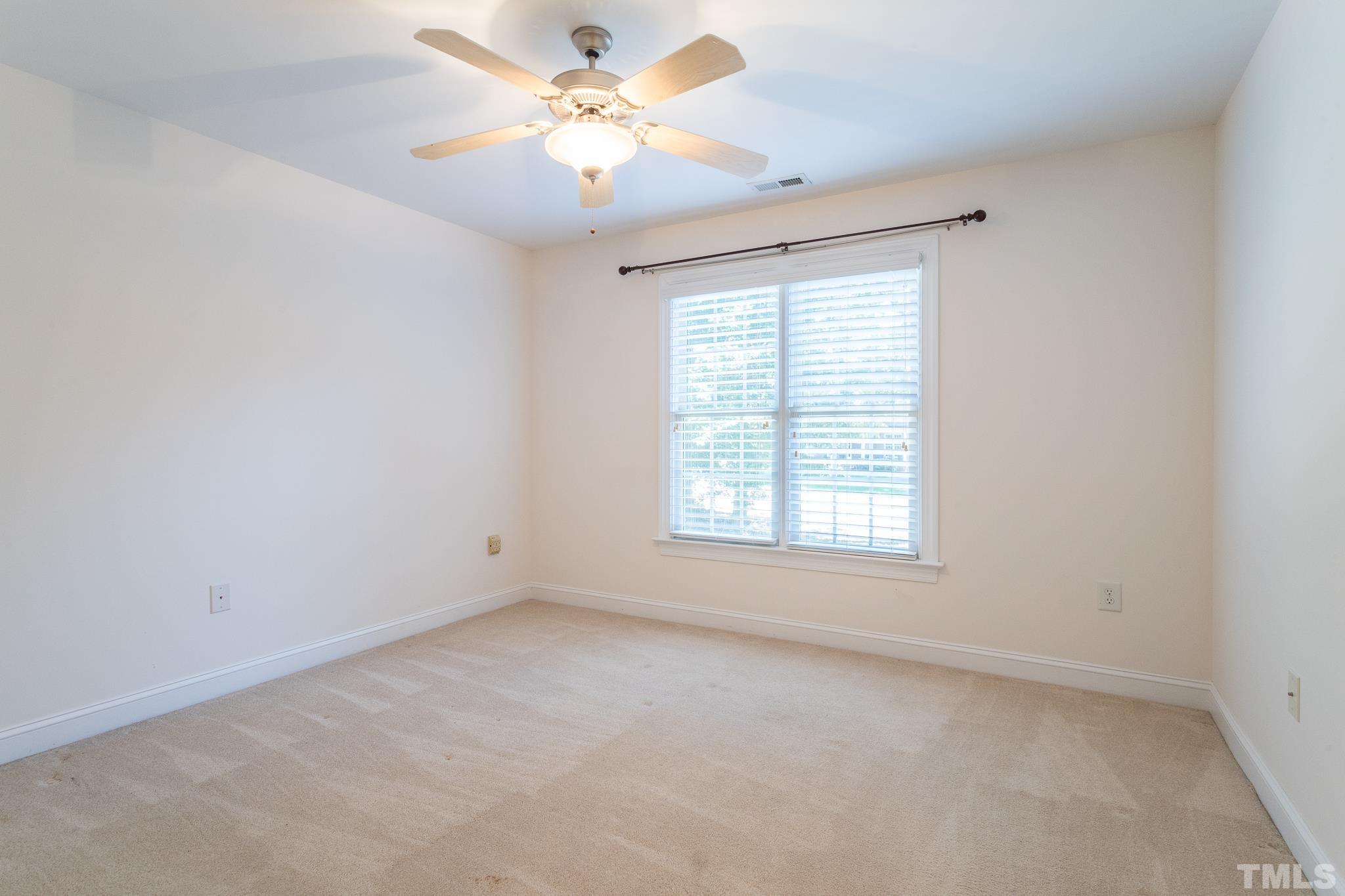 11625 John Allen Road Raleigh, NC 27614 - Photo 4 of 30 an empty room with a window and a fan