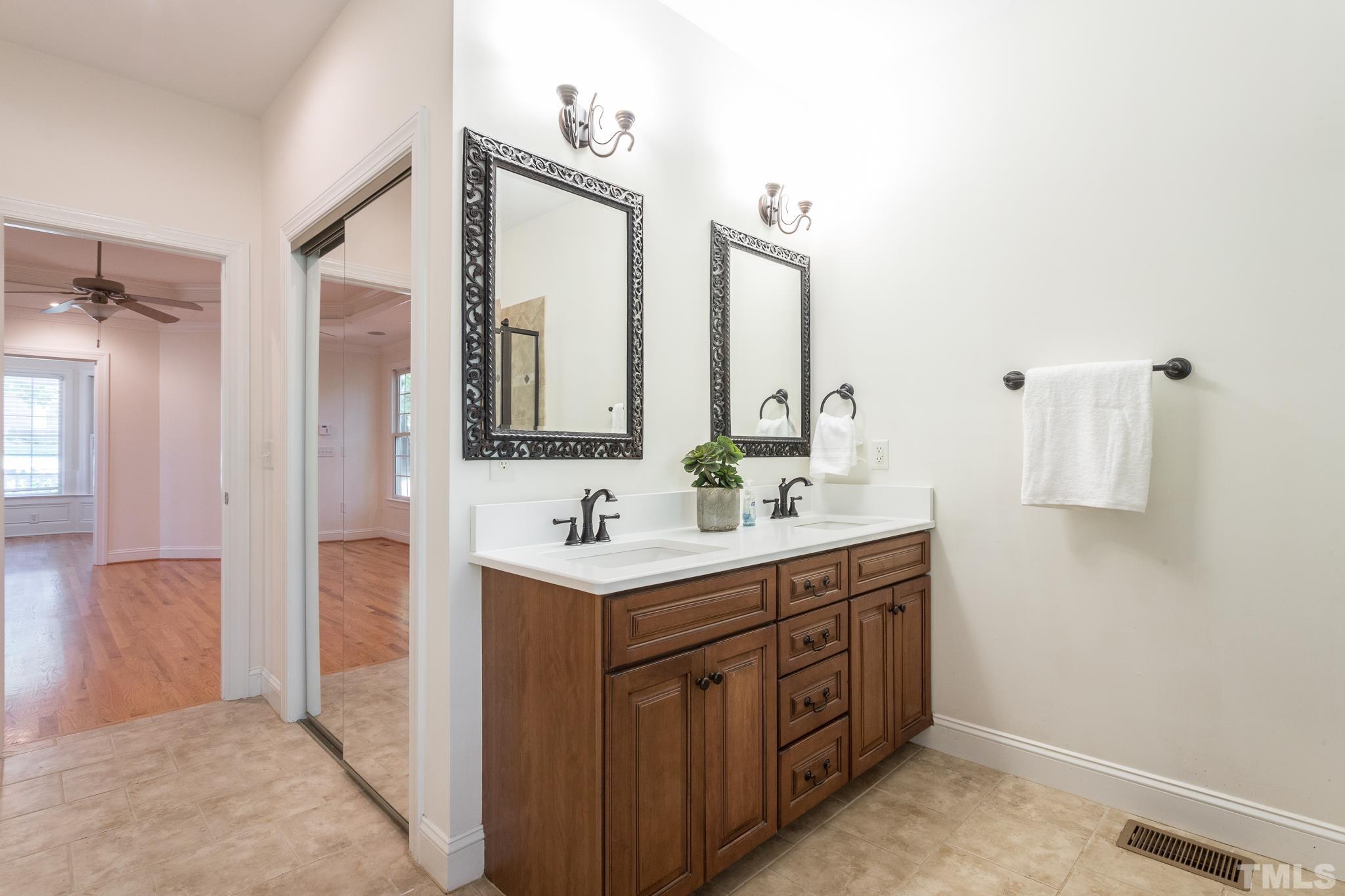 11625 John Allen Road Raleigh, NC 27614 - Photo 6 of 30 a spacious bathroom with a double vanity sink a mirror and a bathtub