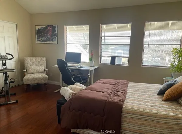 a bedroom with a bed chair and a window