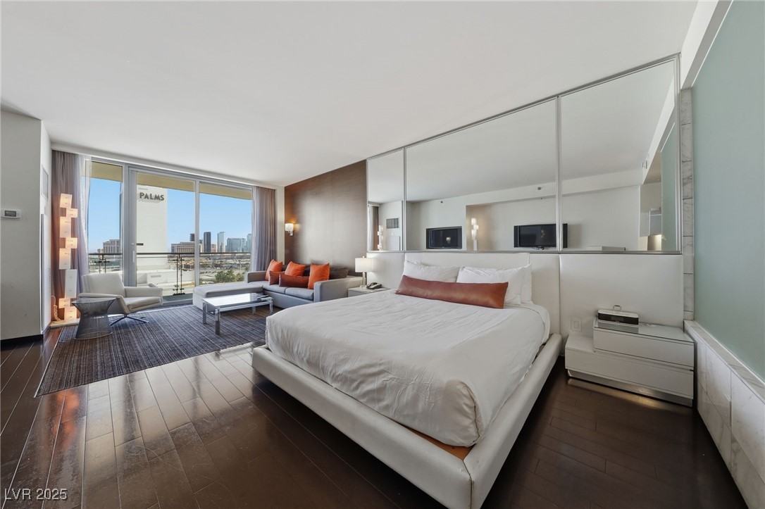 4381 West Flamingo Road, Unit 11308 Las Vegas, NV 89103 - Photo 4 of 26 Bedroom featuring floor to ceiling windows, access to exterior, and dark wood-style flooring