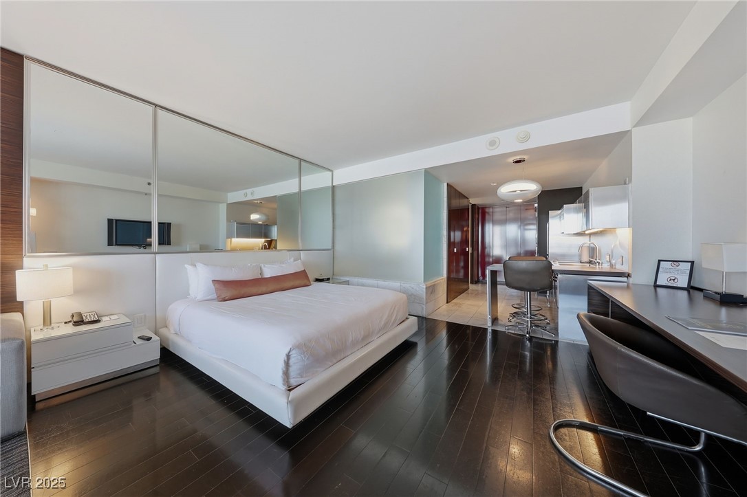4381 West Flamingo Road, Unit 11308 Las Vegas, NV 89103 - Photo 6 of 26 Bedroom featuring dark wood-style flooring