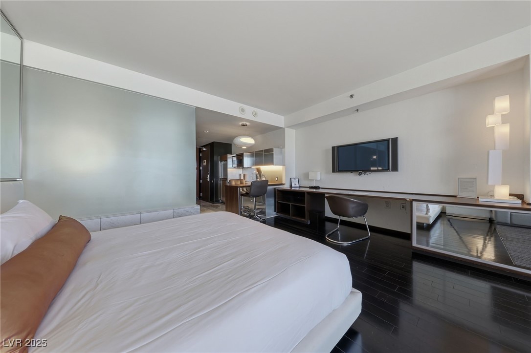 4381 West Flamingo Road, Unit 11308 Las Vegas, NV 89103 - Photo 7 of 26 Bedroom with dark wood-style flooring and freestanding refrigerator
