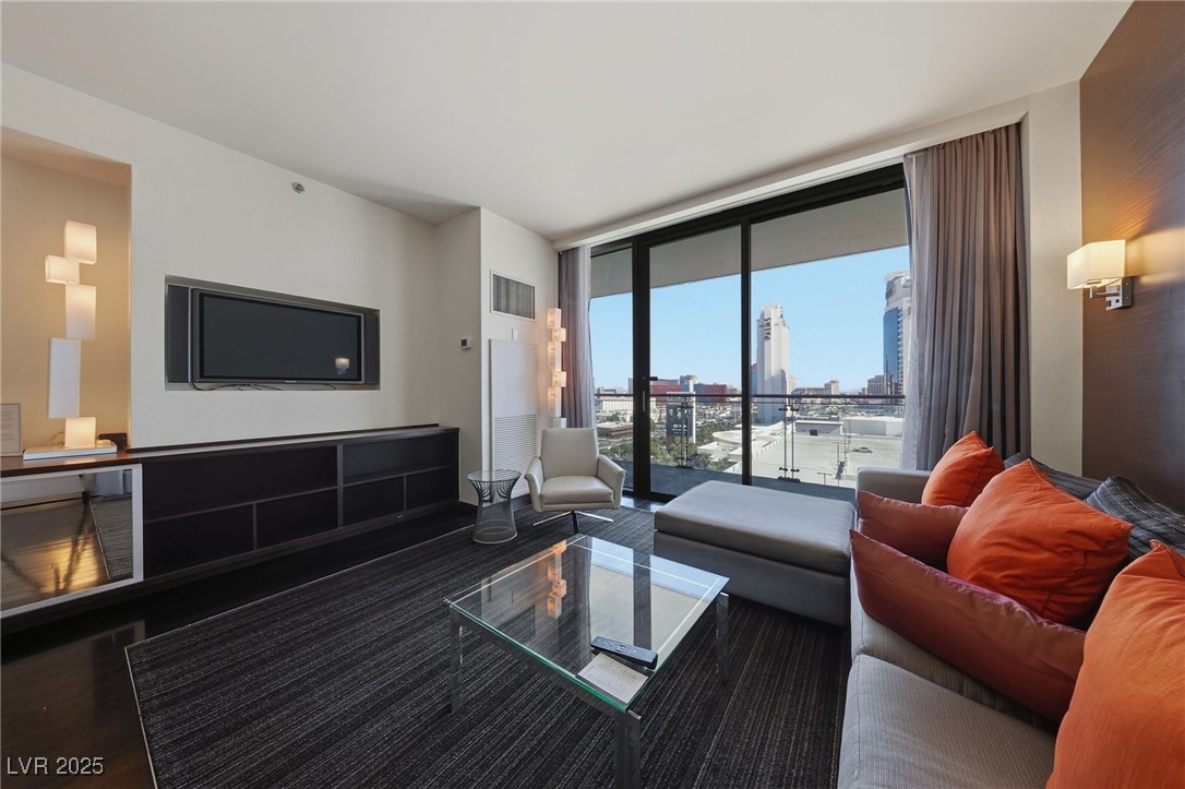 4381 West Flamingo Road, Unit 11308 Las Vegas, NV 89103 - Photo 8 of 26 Living room featuring a wall of windows