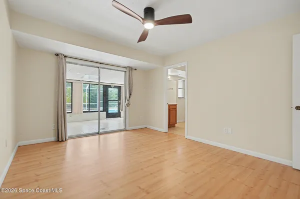 a view of empty room with wooden floor