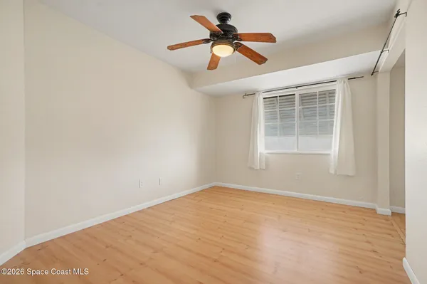 a view of empty room with wooden floor