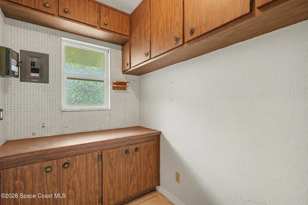 a view of a yard with wooden fence