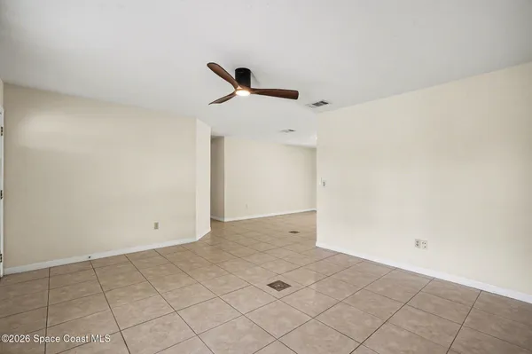 a large white kitchen with a sink and a refrigerator