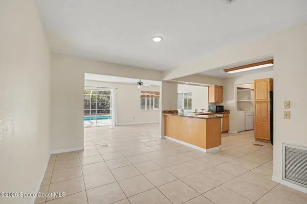 a kitchen with granite countertop a refrigerator and a sink