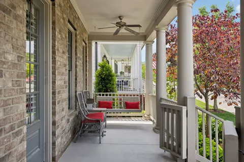 a view of porch with a table and chairs