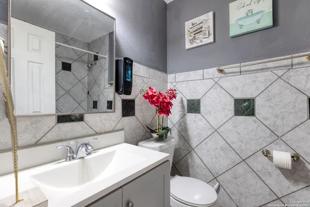 a bathroom with a sink toilet and vanity