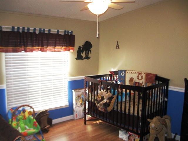 5266 Hugh Woodard Road Springfield, TN 37172 - Photo 14 of 20 Bedroom 2 has laminate floors and a darling western theme baby room.