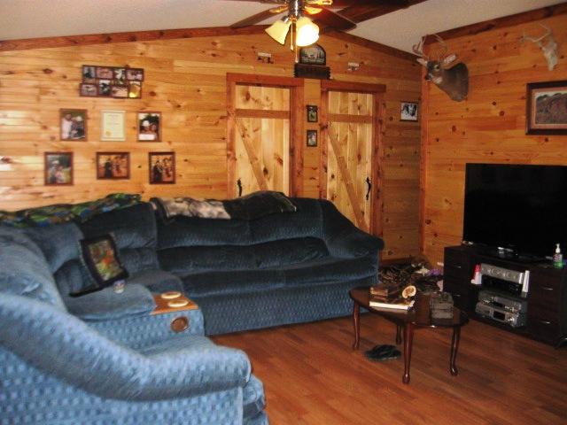 5266 Hugh Woodard Road Springfield, TN 37172 - Photo 3 of 20 Living room features a vaulted ceiling, tongue & groove wood walls & laminate wood flooring.