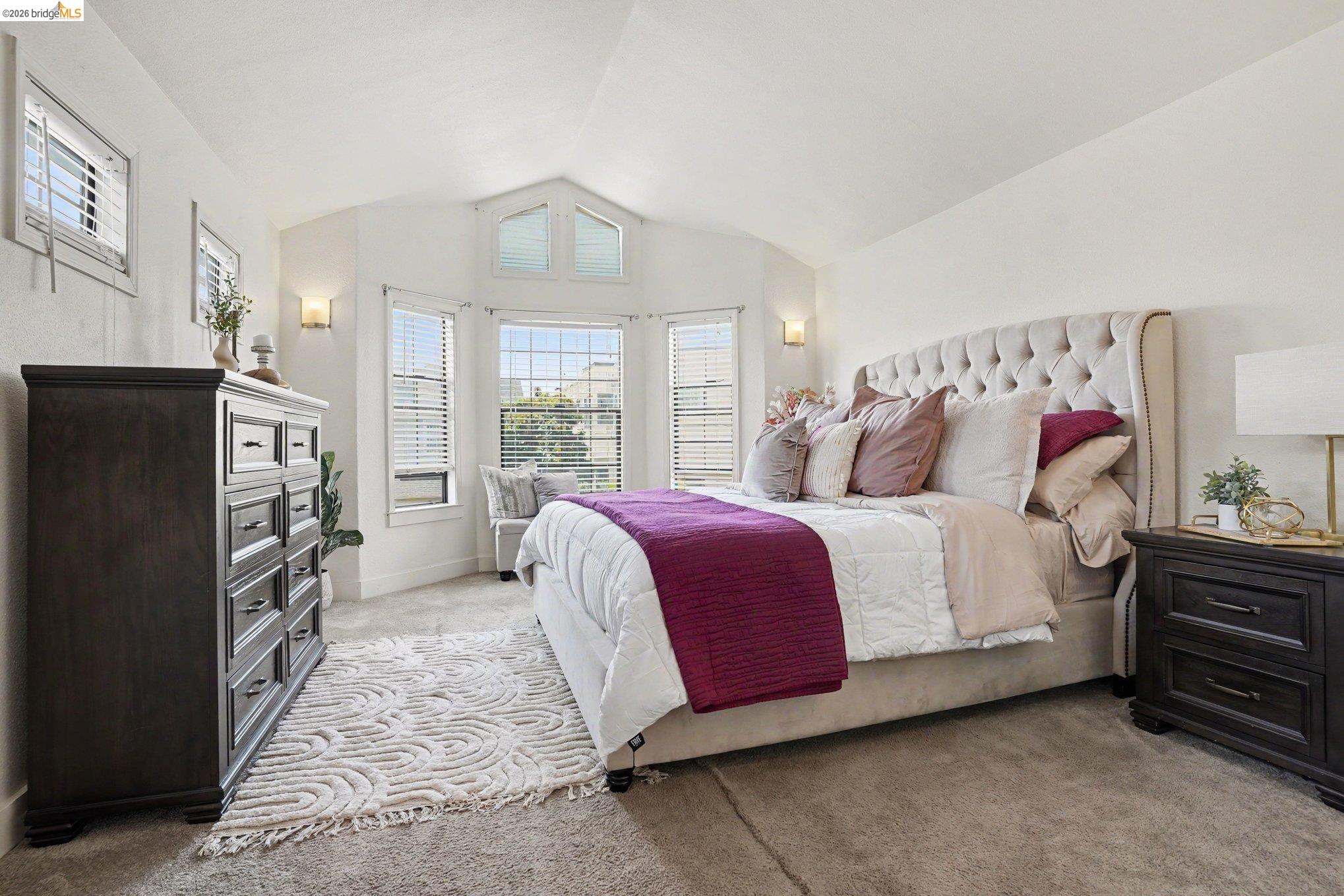 1433 Myrtle Street Oakland, CA 94607 - Photo 11 of 25 Carpeted bedroom featuring a bay window with multiple panes, vaulted ceiling, and recessed lighting