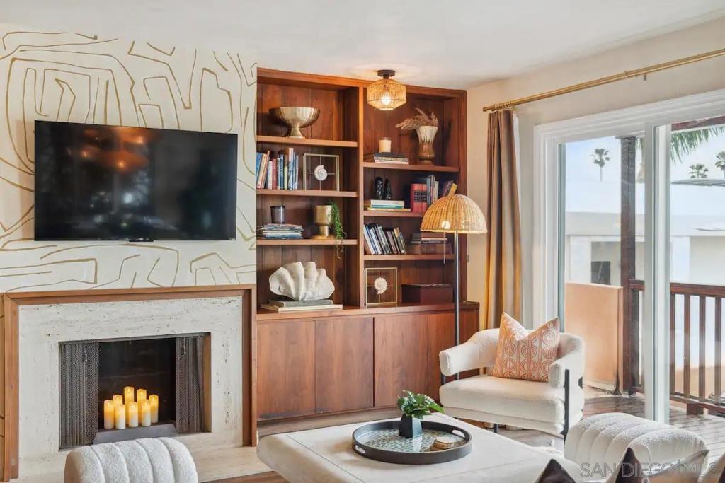 5639 La Jolla Boulevard La Jolla, CA 92037 - Photo 13 of 15 a living room with furniture a flat screen tv and a fireplace