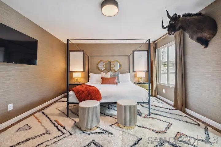 5639 La Jolla Boulevard La Jolla, CA 92037 - Photo 9 of 15 a bedroom with a bed and wooden floor