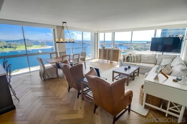a living room with furniture and a floor to ceiling window