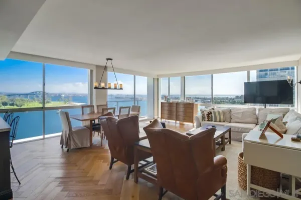 a dining room with furniture a kitchen view and a fireplace