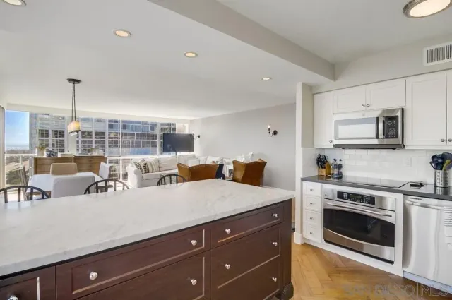 a open kitchen with a stove and a sink