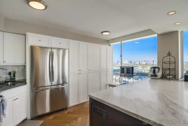a kitchen with stainless steel appliances a refrigerator and wooden cabinets