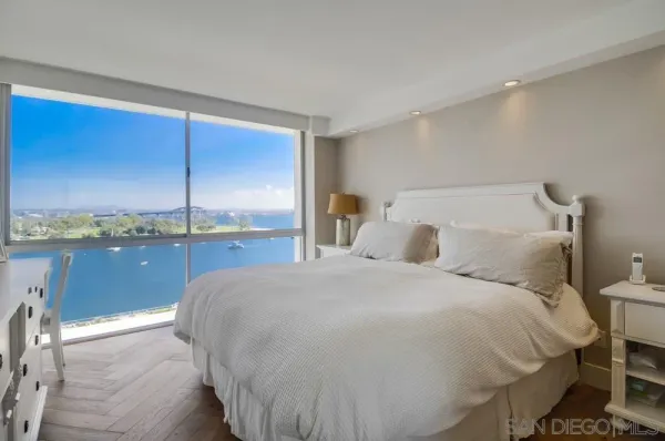 a large bed sitting in a room next to a window