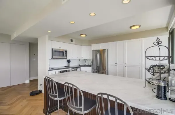 a kitchen with stainless steel appliances a refrigerator and a stove top oven