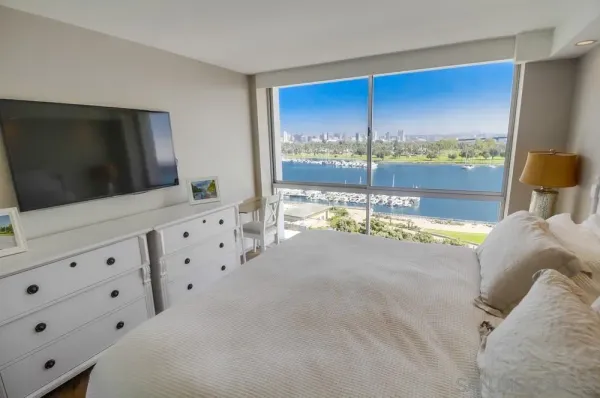 a living room with hard wood floor and flat screen tv