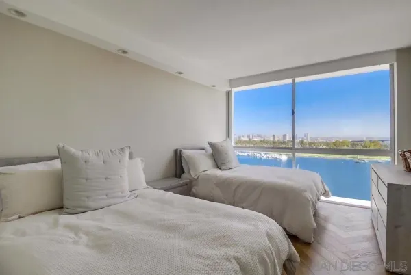 a bedroom with bed and balcony view